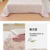 Pink floral quilted bedspread with pink trim and a small green accent on a white background