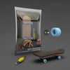A wooden finger skateboard is shown inside a clear plastic bag with accessories and a complete board lying outside.