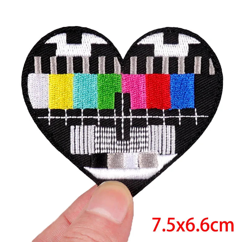Black heart-shaped embroidery patch featuring a stylized rose skull design with colorful accents