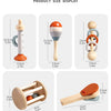 Display of wooden baby rattle bells and a wooden spatula for baby sensory play.