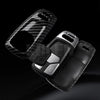 A black key fob cover with a carbon fiber texture is shown against a dark background.
