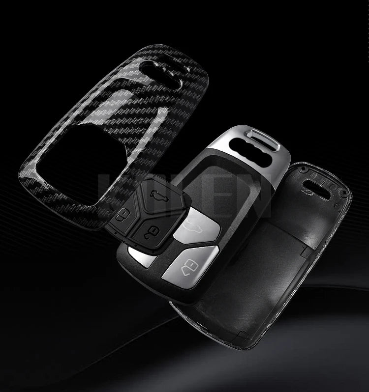 A black key fob cover with a carbon fiber texture is shown against a dark background.