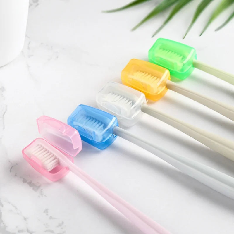 A collection of colorful protective toothbrush head covers with travel clips arranged on a white marble surface.