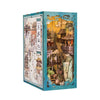 A box containing a DIY book nook kit featuring an elaborate scene with traditional architecture and foliage.
