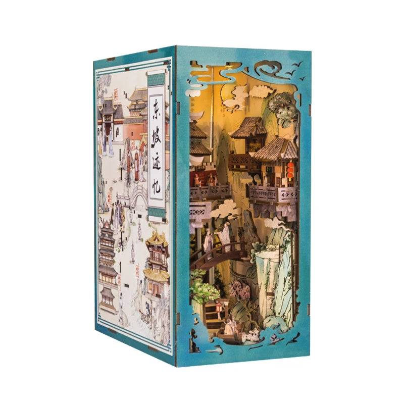 A box containing a DIY book nook kit featuring an elaborate scene with traditional architecture and foliage.