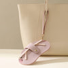 A light pink retro lychee pattern PU leather glasses case with a beige strap is shown against a neutral background.