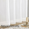 White sheer voile curtains displayed vertically against a white wall.