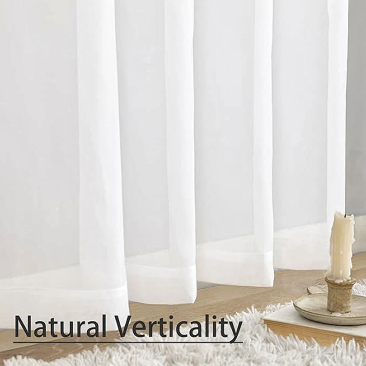White sheer voile curtains displayed vertically against a white wall.
