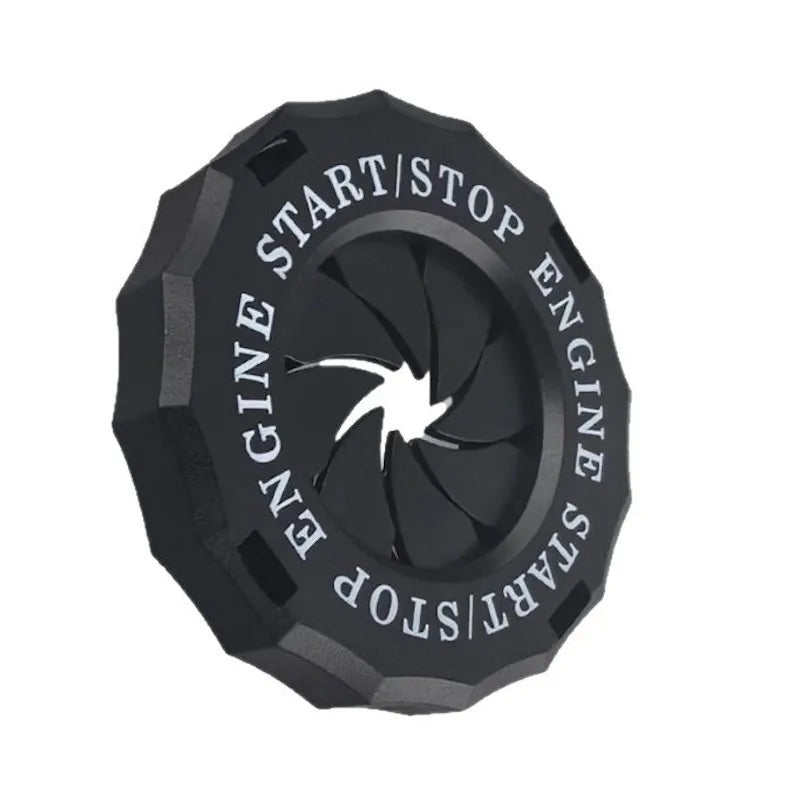 Black decorative trim cover for a rotating engine start or stop button.