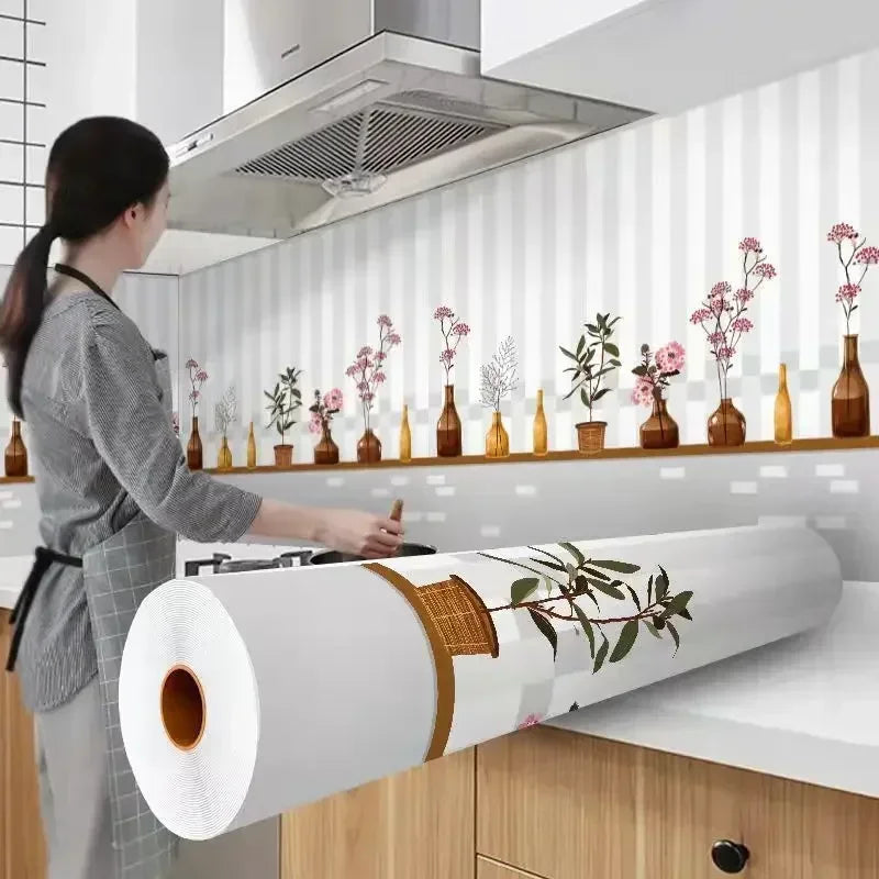 A person is applying a roll of self-adhesive kitchen splashback sticker wallpaper to a white tiled wall.