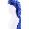A bright blue satin sleep bonnet tied in a bow, displayed on a white mannequin head.