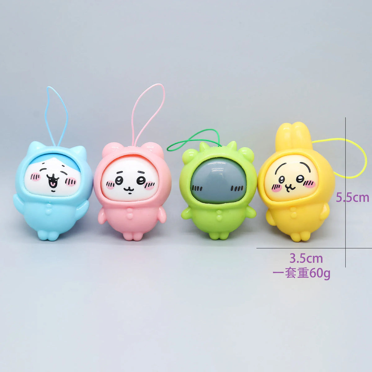 A set of four cute PVC bag pendant dolls in pastel colors including blue, pink, green, and yellow.