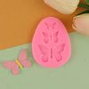 A pink silicone mold shaped like an egg with butterfly designs, next to a small pink butterfly.
