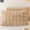 A fluffy beige quilted velvet pillow is displayed on a white surface.