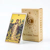 A deck of tarot cards and guidebook in a light brown box with gold accents.