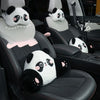Black car seats with white panda plush headrests and lumbar support cushions.
