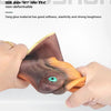 A hand is holding a realistic dinosaur hand puppet toy with textured skin and an eye detail.