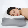 A woman is sleeping comfortably on a gray memory foam pillow for neck pain relief.