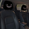A pair of horror-themed car headrest covers featuring creepy face designs on black leather seats.