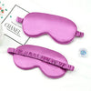 A pink silk sleep mask with a ruffled edge is shown next to a box labeled Chanel.