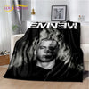 A black throw blanket featuring a portrait of Eminem with smoke effects.