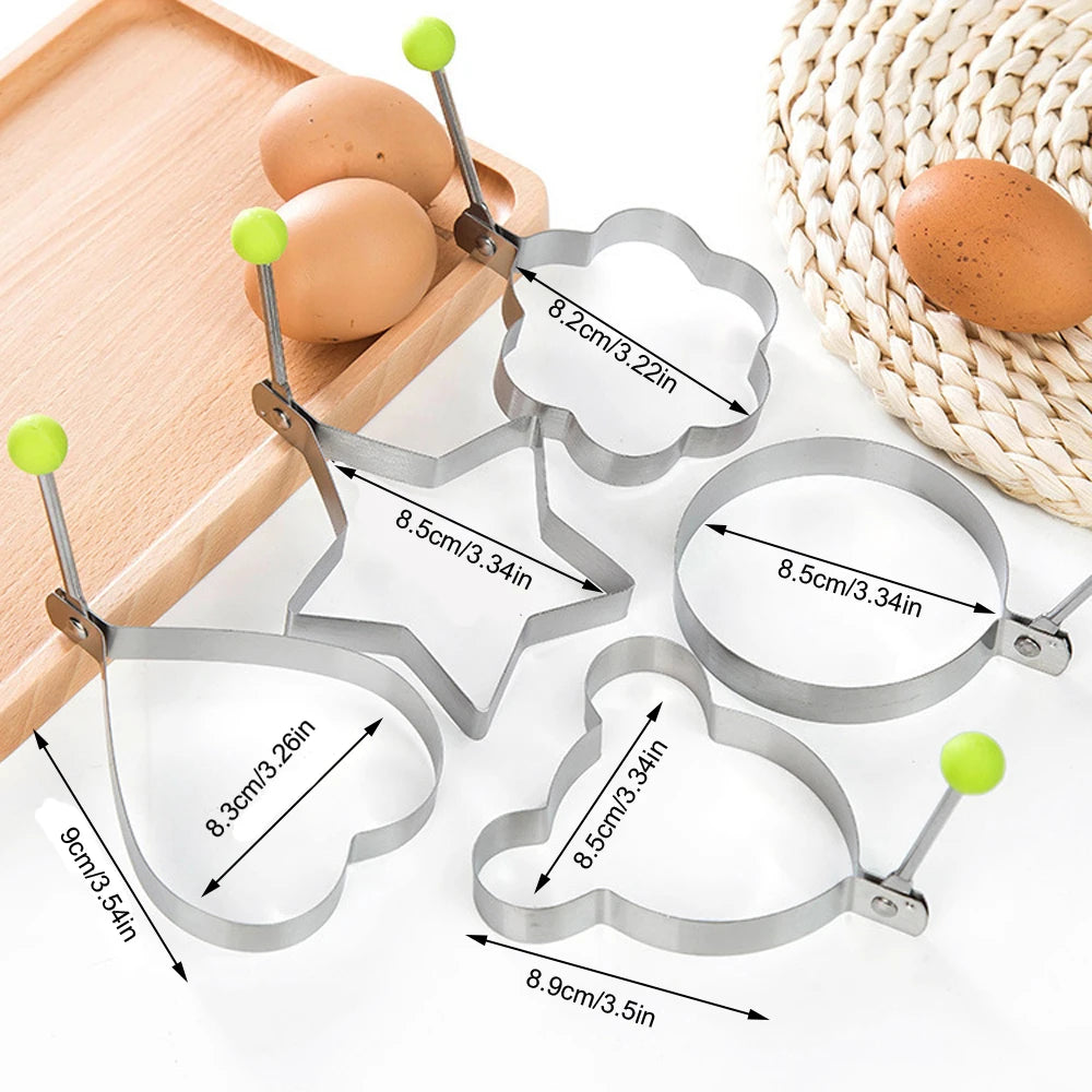 A set of five stainless steel molds for eggs and pancakes, including various shapes and sizes.