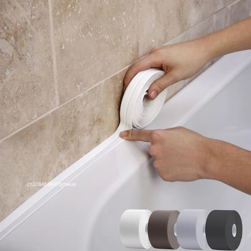 A hand is applying self-adhesive waterproof sealing tape to a gap between a white bathtub and a tiled wall.