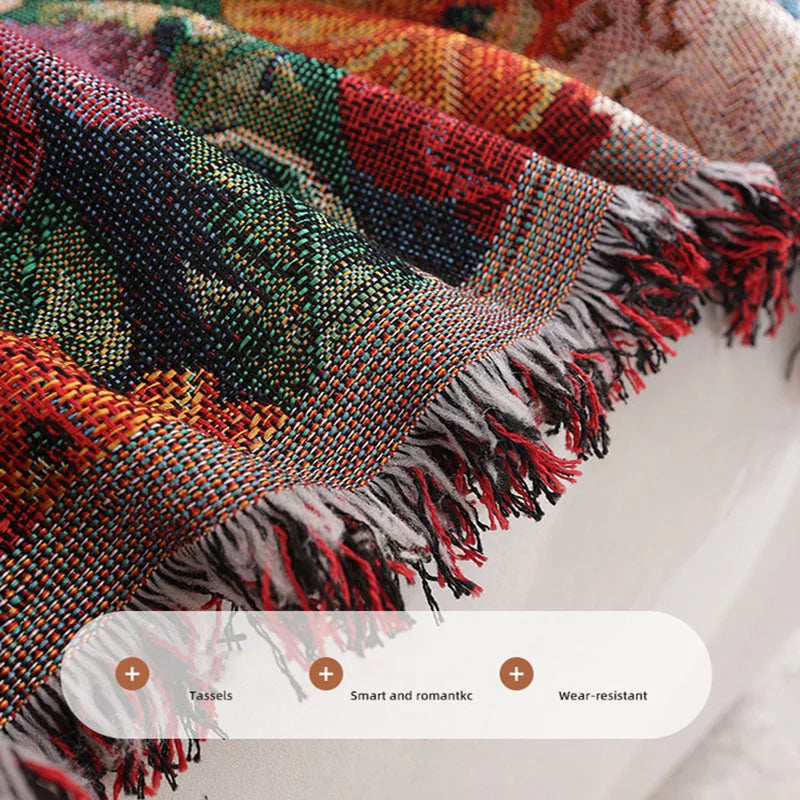 A close-up of a romantic floral jacquard sofa blanket with colorful threads and tassels.