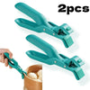 Two teal silicone gripper clips used to hold a bowl or plate.