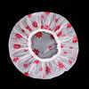 A white sheer shower cap with a pink background and red floral patterns.