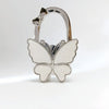 Silver foldable butterfly handbag hook with decorative details.