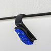 Black clip with blue crystal rhinestones used to secure sunglasses on a visor.