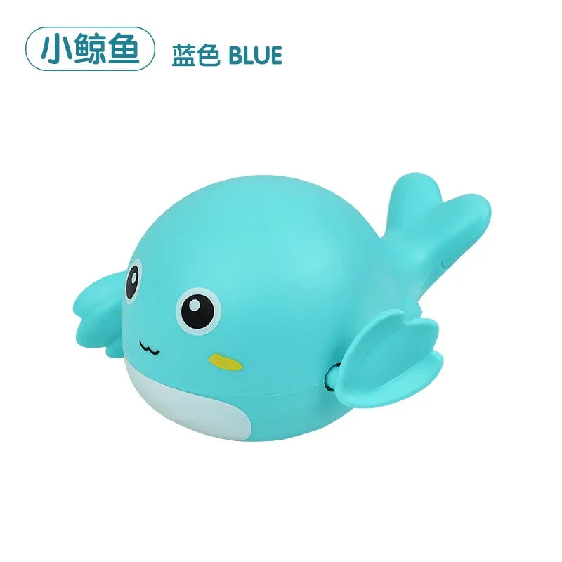 A light blue cartoon whale bath toy featuring large eyes and fins.