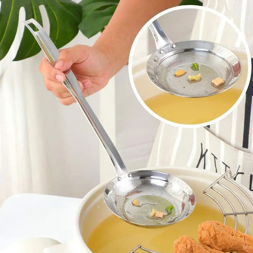 A hand is using a stainless steel fine mesh skimmer spoon to remove oil and foam from liquid in a pot.