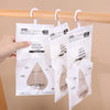 White hanging bags of moisture absorbent material for wardrobe and closet