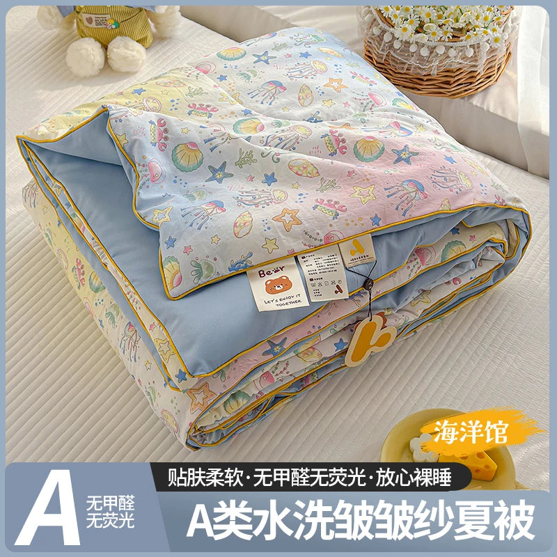 A lightweight summer quilt featuring a playful cartoon print with various colorful patterns.