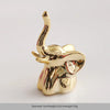 Gold-colored ceramic elephant and rabbit jewelry holder with a curved horn design