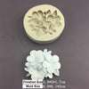 A finished white silicone mold of five flowers with a corresponding mold size shown below it.