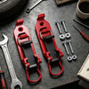 Two red heavy-duty quick release shovel holders resting on a dark surface with tools and hardware.