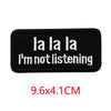 Black embroidered iron-on letter patch with white text that reads I'm not listening