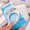 A hand holds a package of disposable toilet seat covers designed for travel and waterproof use.
