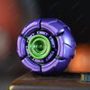 A purple fidget spinner with a green center is shown on a surface.