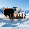 A foldable handheld car vacuum cleaner with various nozzles and accessories resting on a snowy surface.