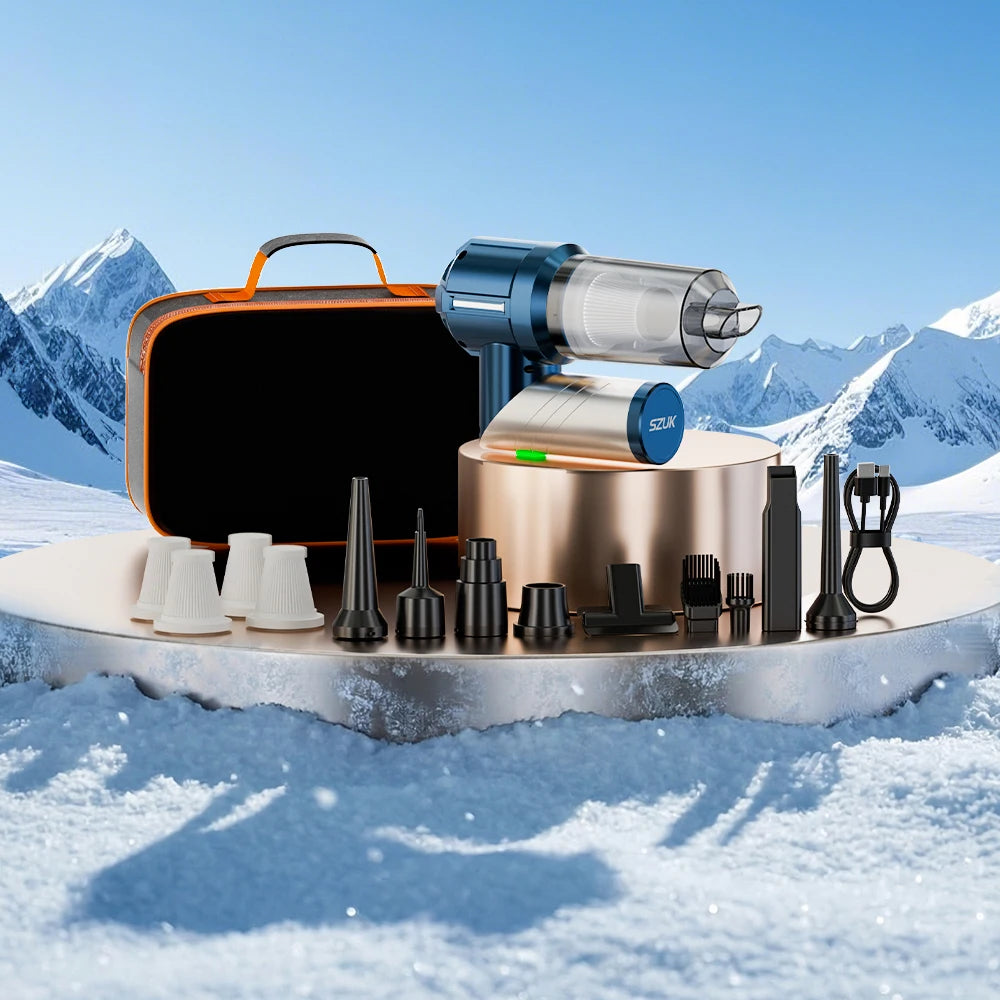 A foldable handheld car vacuum cleaner with various nozzles and accessories resting on a snowy surface.