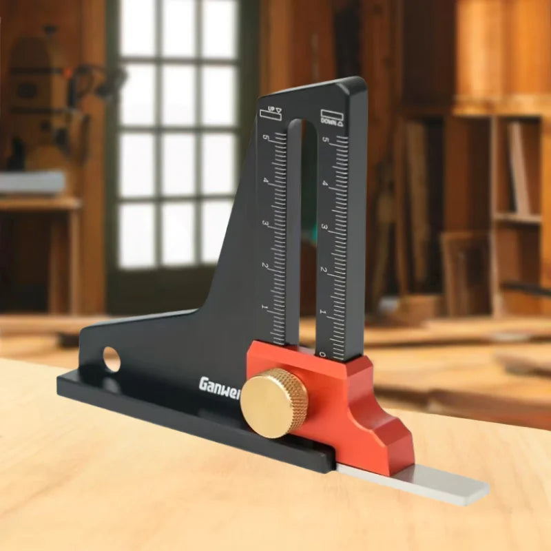 A black precision aluminum height setting gauge with a brass adjustment knob rests on a wooden surface.