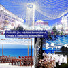 Outdoor string lights creating a romantic atmosphere over a sea view with tables set for an event
