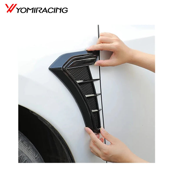 Hands installing a black TPU side vent cover on a white car body.