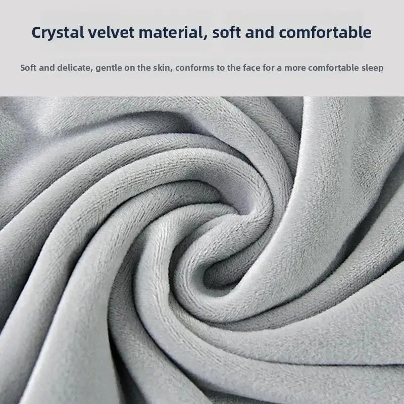 Close-up of a soft, gray velvet material forming a swirling texture for a travel neck pillow.