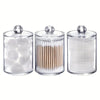 Three clear acrylic jars with lids holding cotton balls and swabs.
