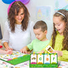 A woman and two children are using CVC word flashcards for early reading and phonics practice.